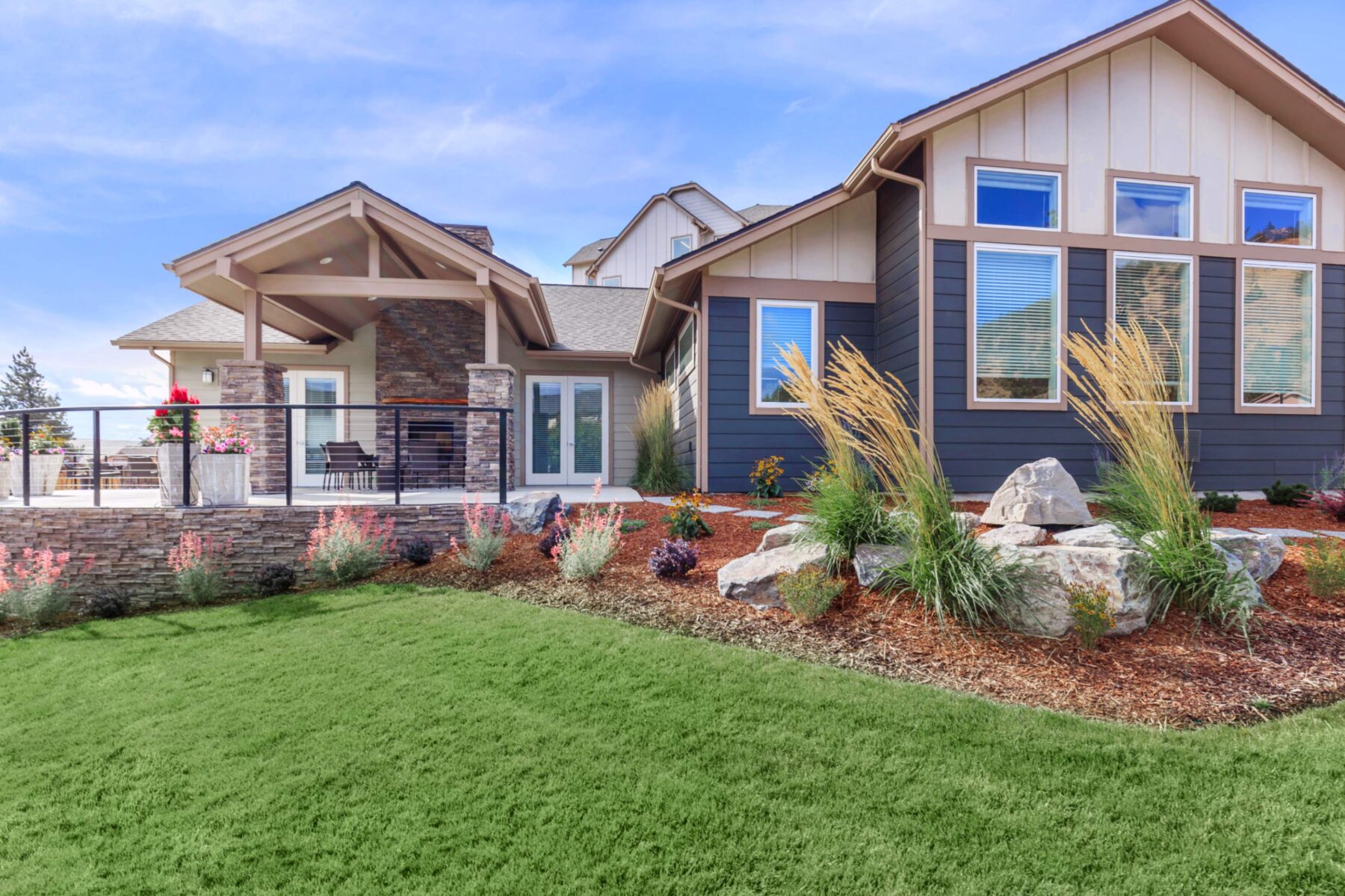 Building exterior with patio showing grass and landscaping