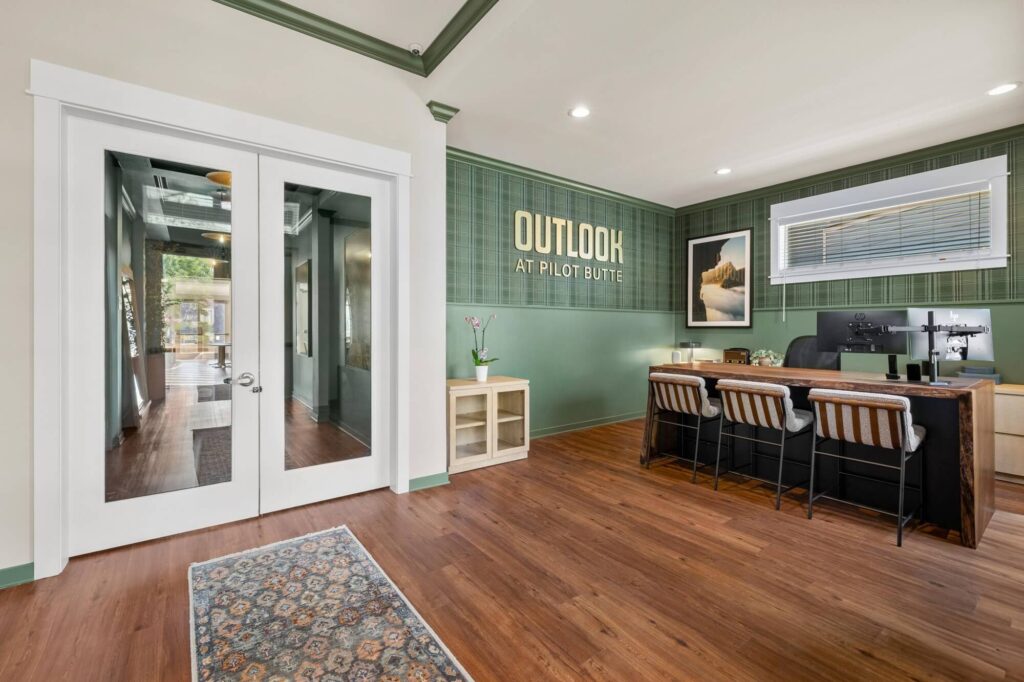 Leasing office reception area with computers and double doors to hallway of clubhouse