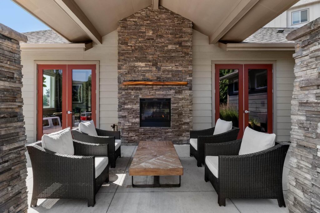 Exterior lounge seating area with fireplace