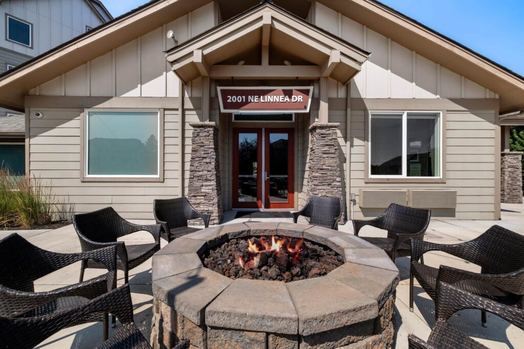 Exterior lounge space with fireplace in the center of outdoor seating