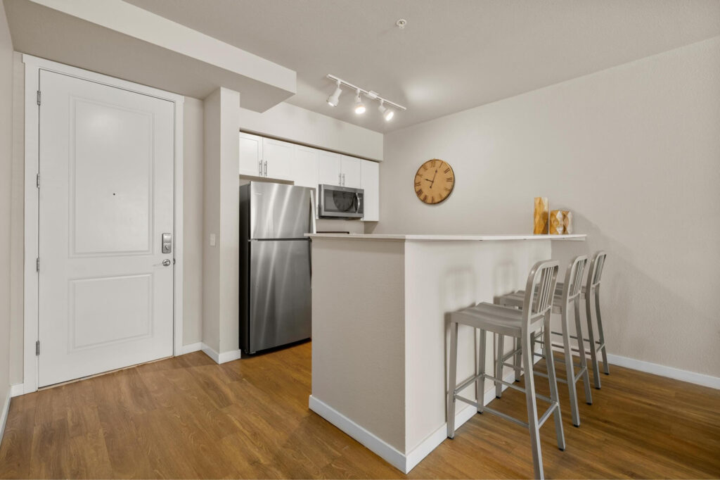 Kitchen space with bar height countertops and seating