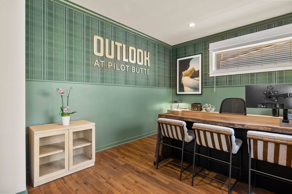 Leasing office reception area with computers and Outlook at Pilot Butte sign