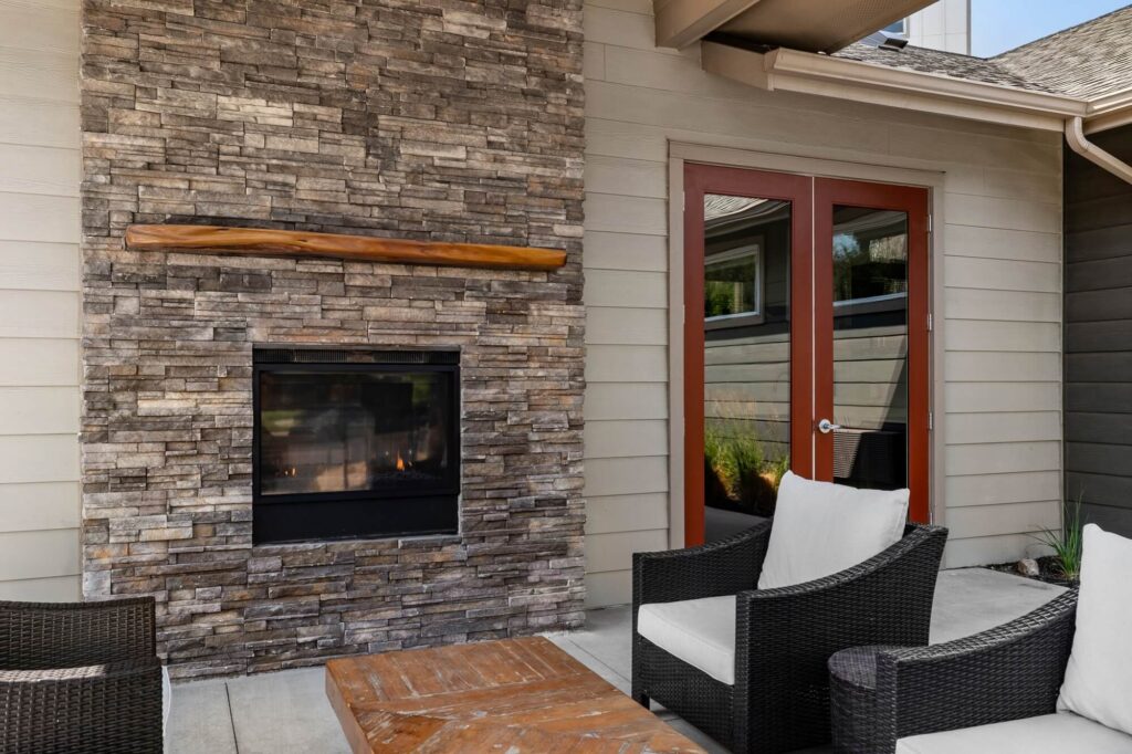 Exterior lounge seating area with fireplace