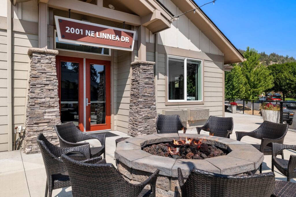 Exterior lounge space with fireplace in the center of outdoor seating
